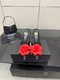 Black slingback heels with red rose clips and gold stiletto heels