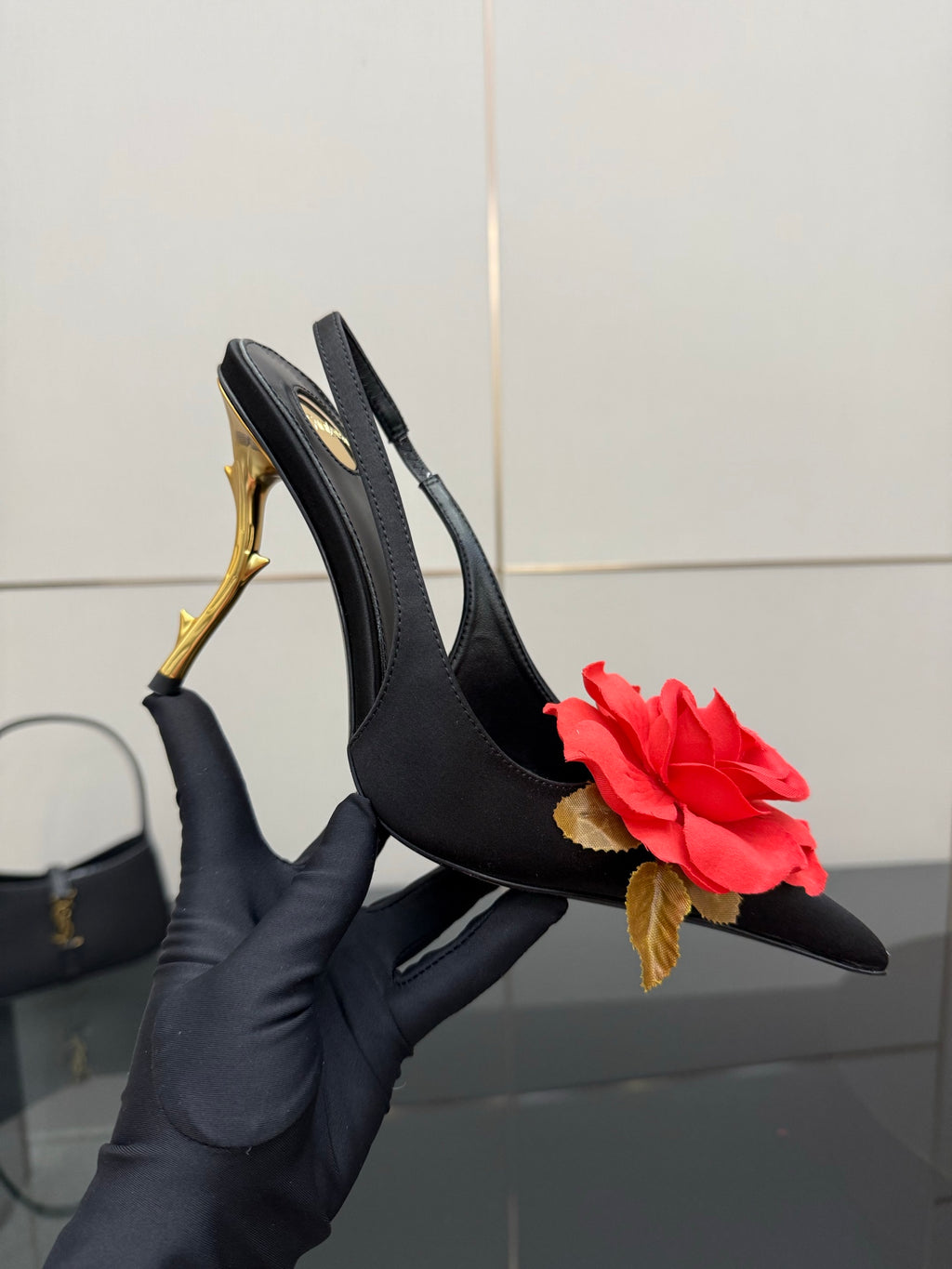 Black slingback heel with gold stiletto and red rose embellishment, open front