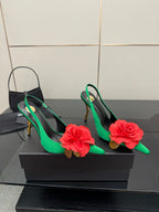 Pair of green slingback pumps with red flower appliques and gold-tone high heels