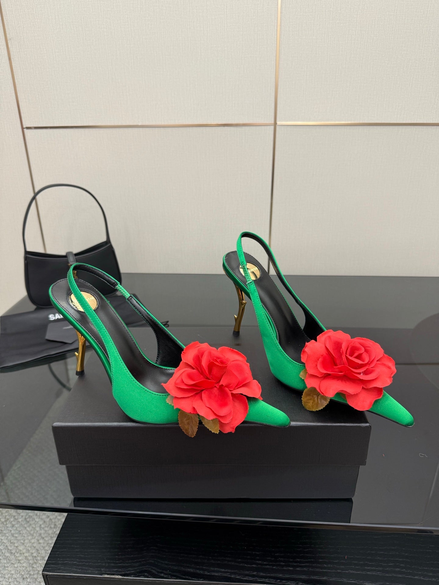 Pair of green slingback pumps with red flower appliques and gold-tone high heels