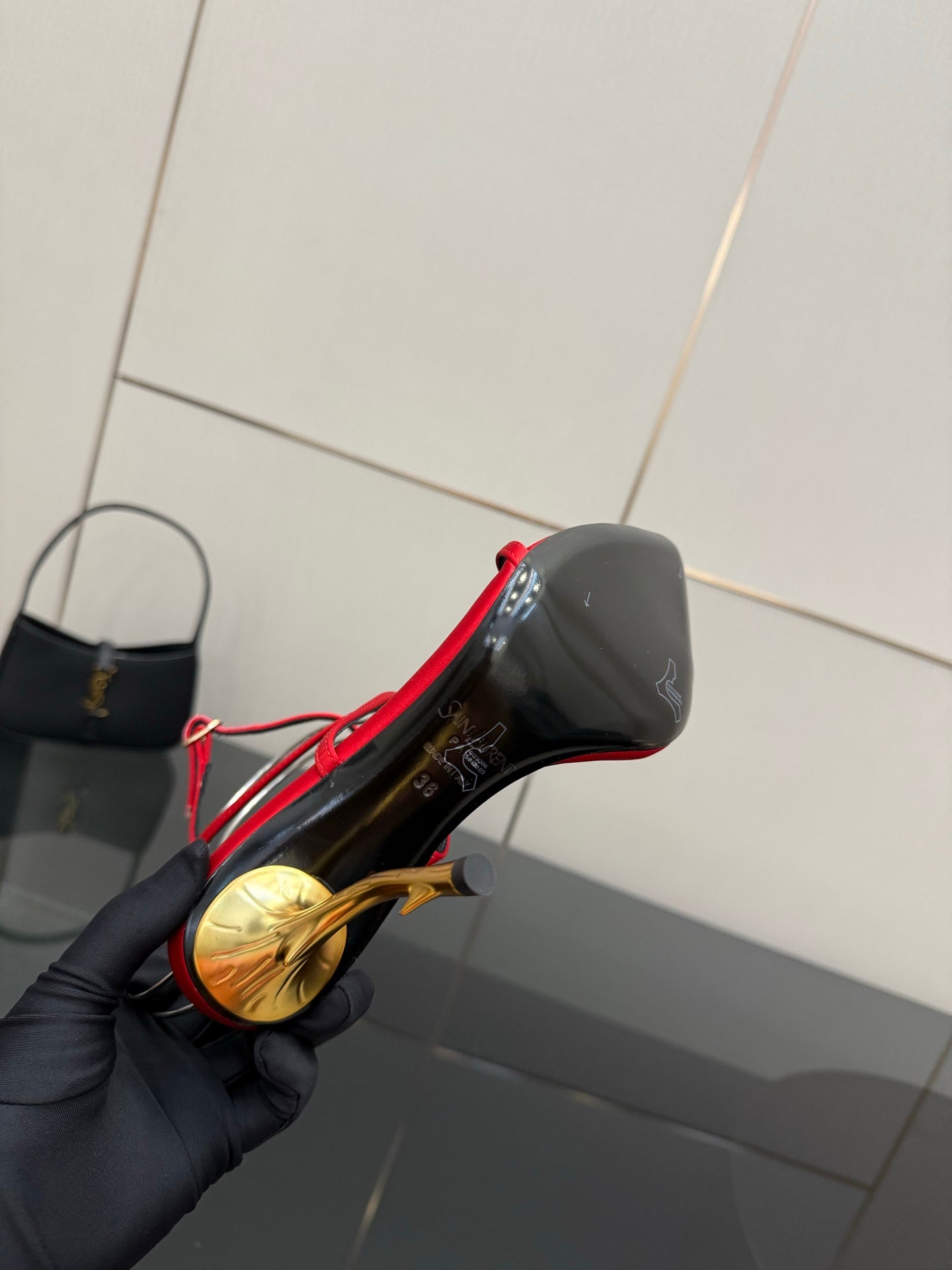 YSL ladies heeled sandal close-up with gold heel and red upper, black strap details