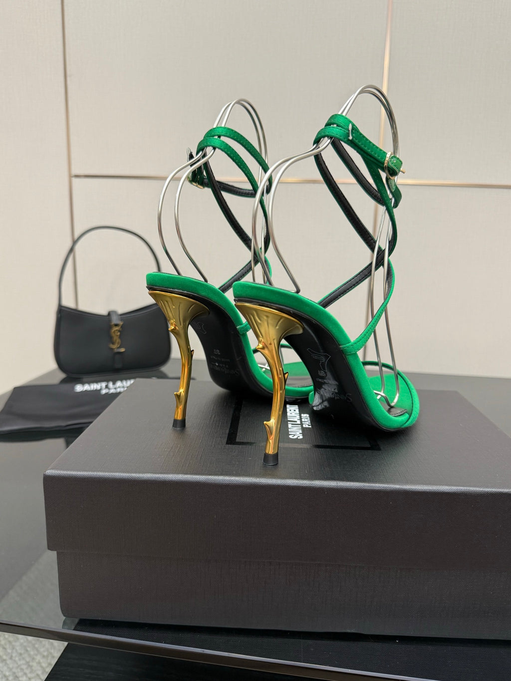 Green high-heel sandals with gold-toned stiletto heels and thin crisscross straps