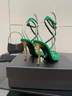 Green high-heel sandals with gold-toned stiletto heels and thin crisscross straps