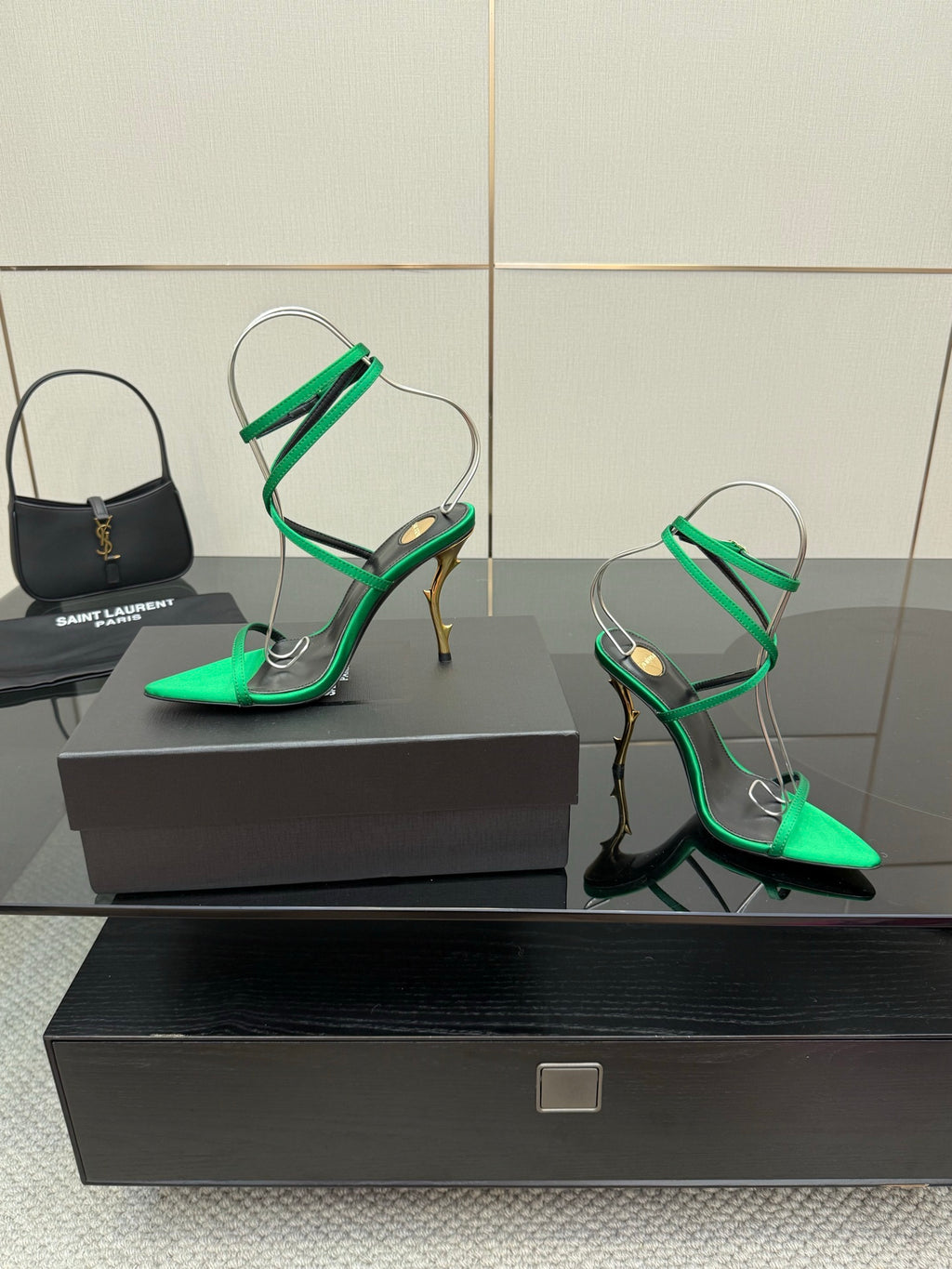 Green strappy high heels with pointed toe, thin ankle straps, and gold-toned heel