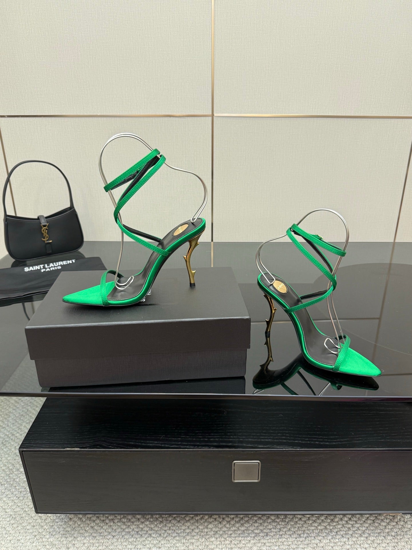 Green strappy high heels with pointed toe, thin ankle straps, and gold-toned heel