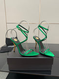 Green strappy high-heel sandals with thin ankle straps and gold-toned stilettos