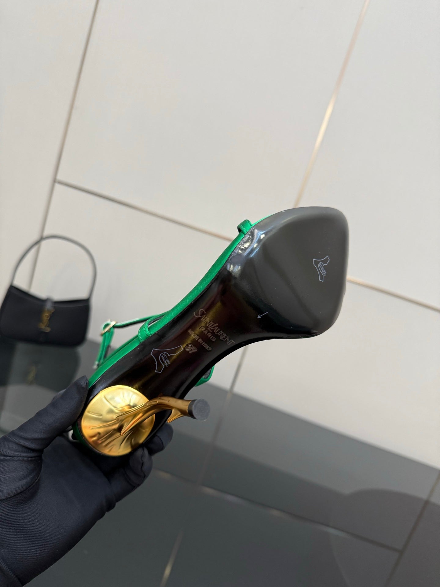 Green-trimmed black sole of a high-heel sandal with YSL logo detail