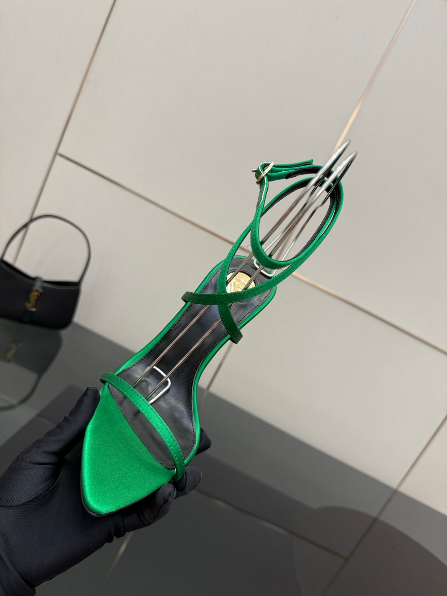 Green strappy pointed-toe sandal with thin ankle straps, shown at an angled side view