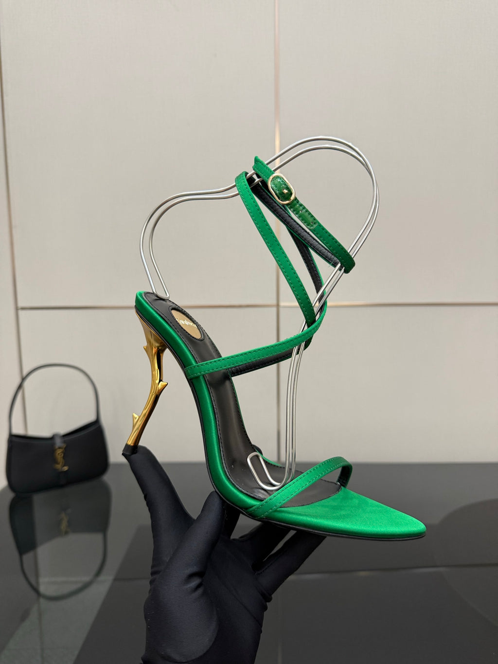 Single green strappy high-heel sandal with gold-toned stiletto heel and ankle strap