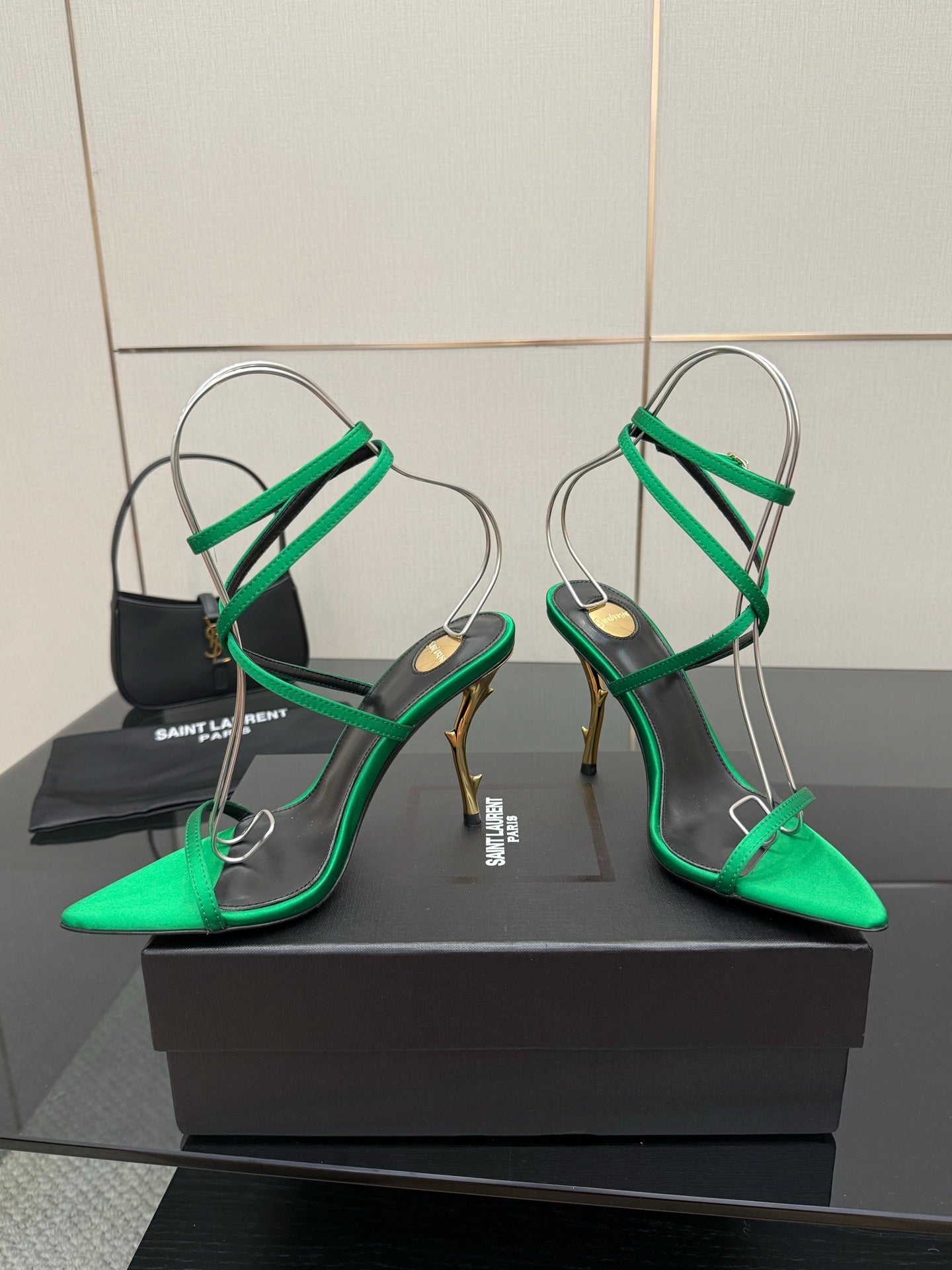 Green pointed-toe sandals with thin straps and high stiletto heel in gold tone