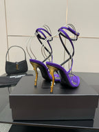 Purple open-toe strappy high-heel sandals with gold-tone heels, side view