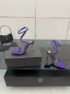 Purple strappy high-heel sandals with lace-like ankle straps and pointed toe
