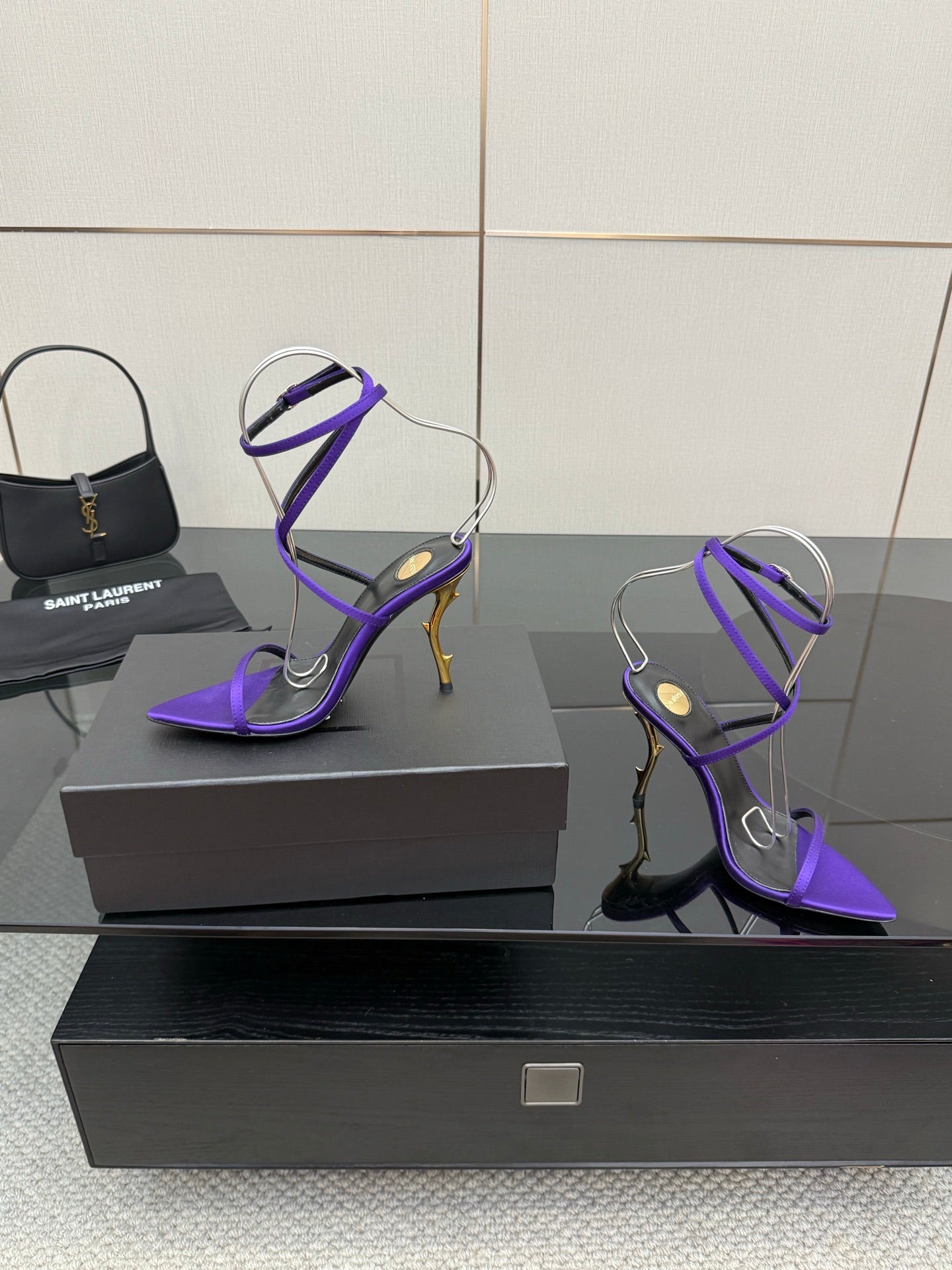 Purple strappy high-heel sandals with lace-like ankle straps and pointed toe