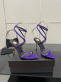 Purple strappy high-heel sandals with thin ankle straps and open toes