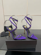 Purple strappy high-heel sandals with thin ankle straps and open toes