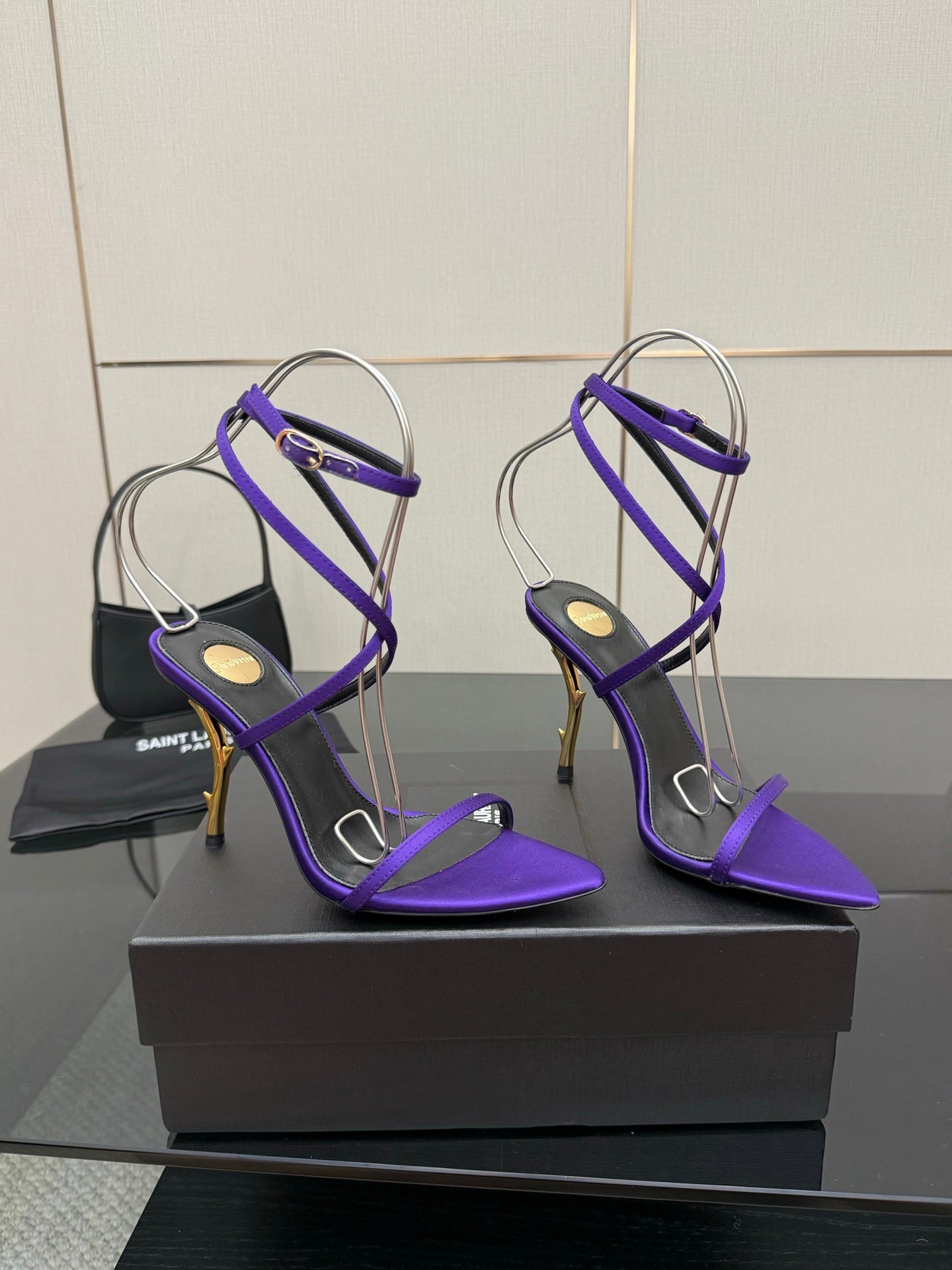 Purple strappy high-heel sandals with thin ankle straps and open toes