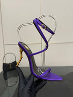 Purple strappy high-heel sandal with gold-tone stiletto heel, side profile