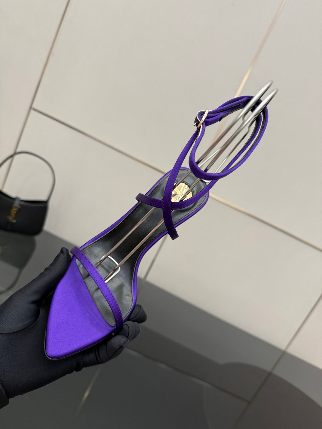 Purple strappy high-heel sandal with thin straps and gold-tone heel, angled view
