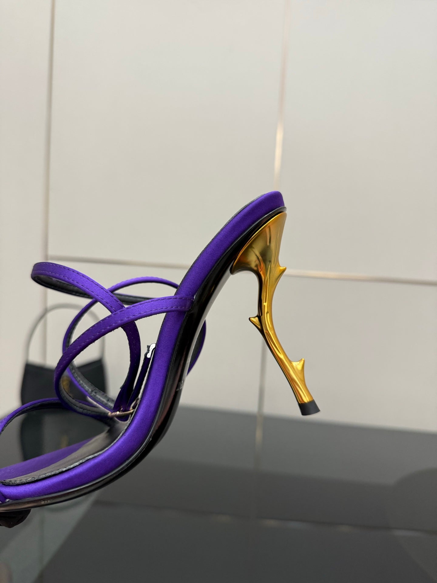 Purple strappy high-heel sandal showing open toe and gold-tone stiletto heel