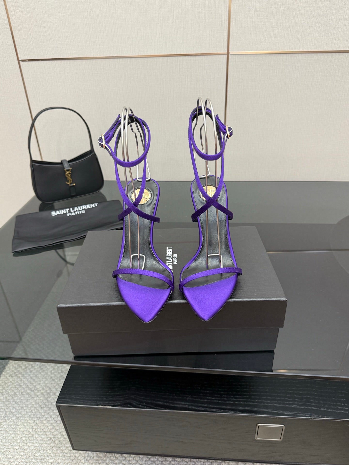 Purple strappy high-heel sandals with thin crisscross ankle straps and stiletto heels