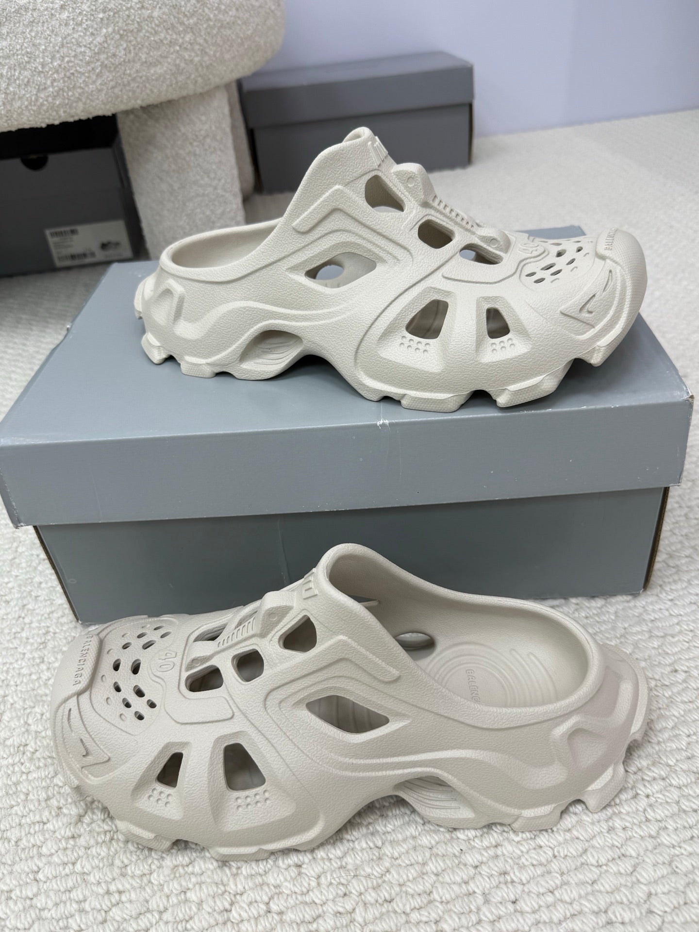 Balenciaga white slide sandals, side view with vented upper and cutouts
