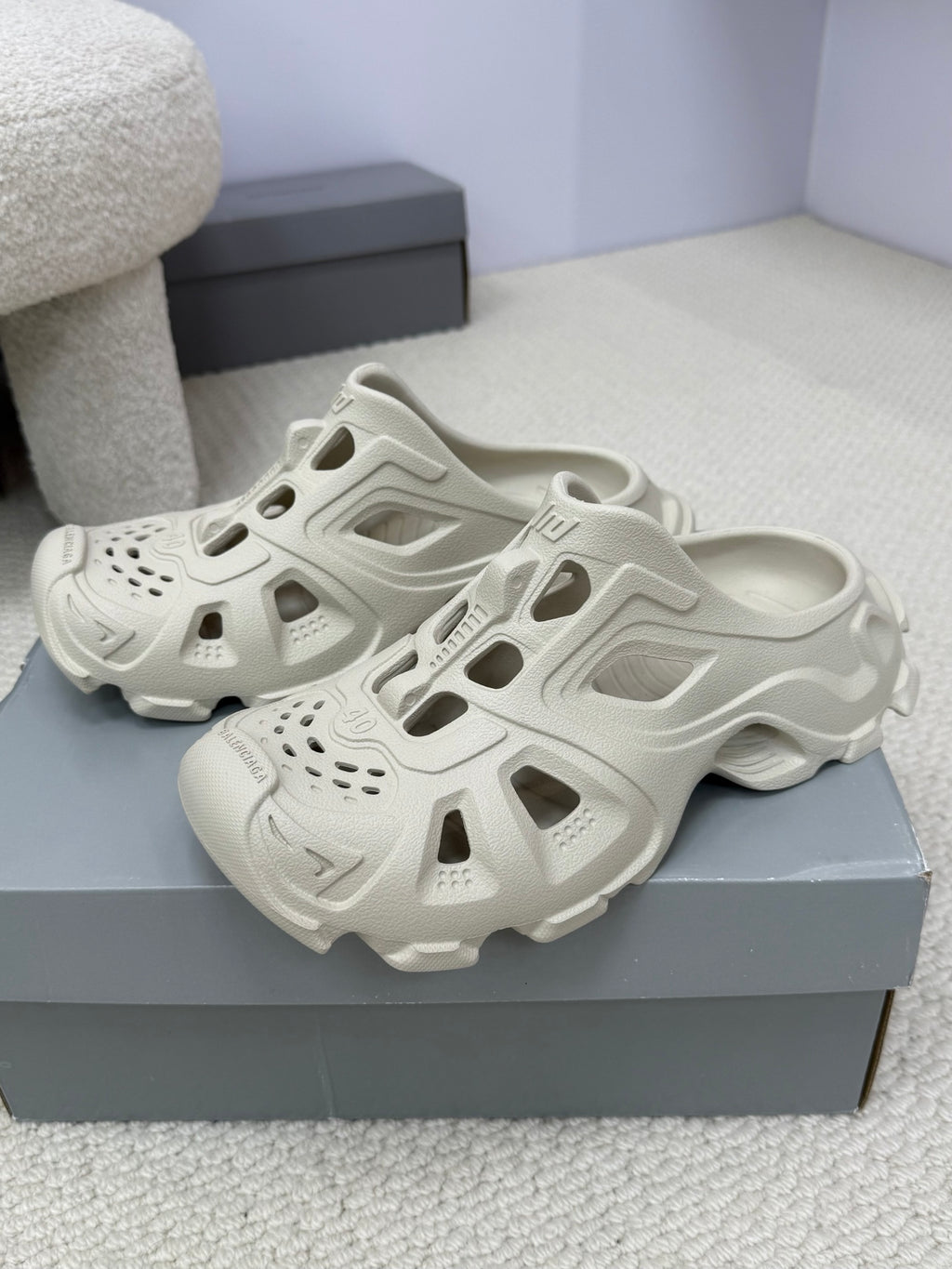 Balenciaga white slide sandals pair on box, perforations and cutout details