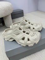 Balenciaga white slide sandals pair, chunky tread sole and cutout design