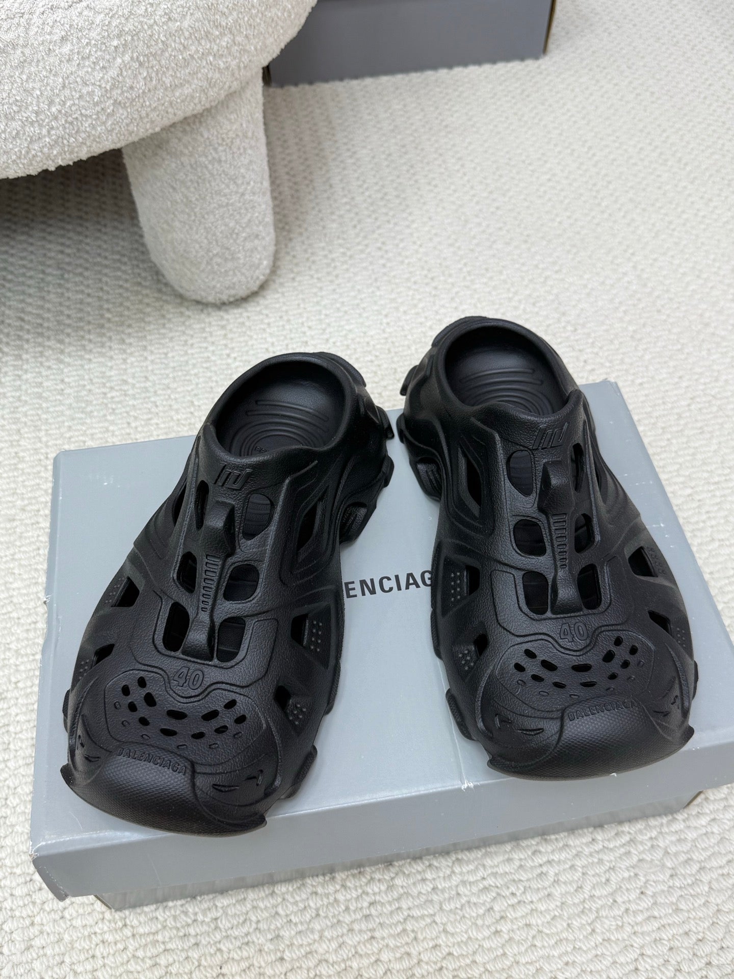Balenciaga black slide sandals with cutout upper, perforated toe, and chunky sole