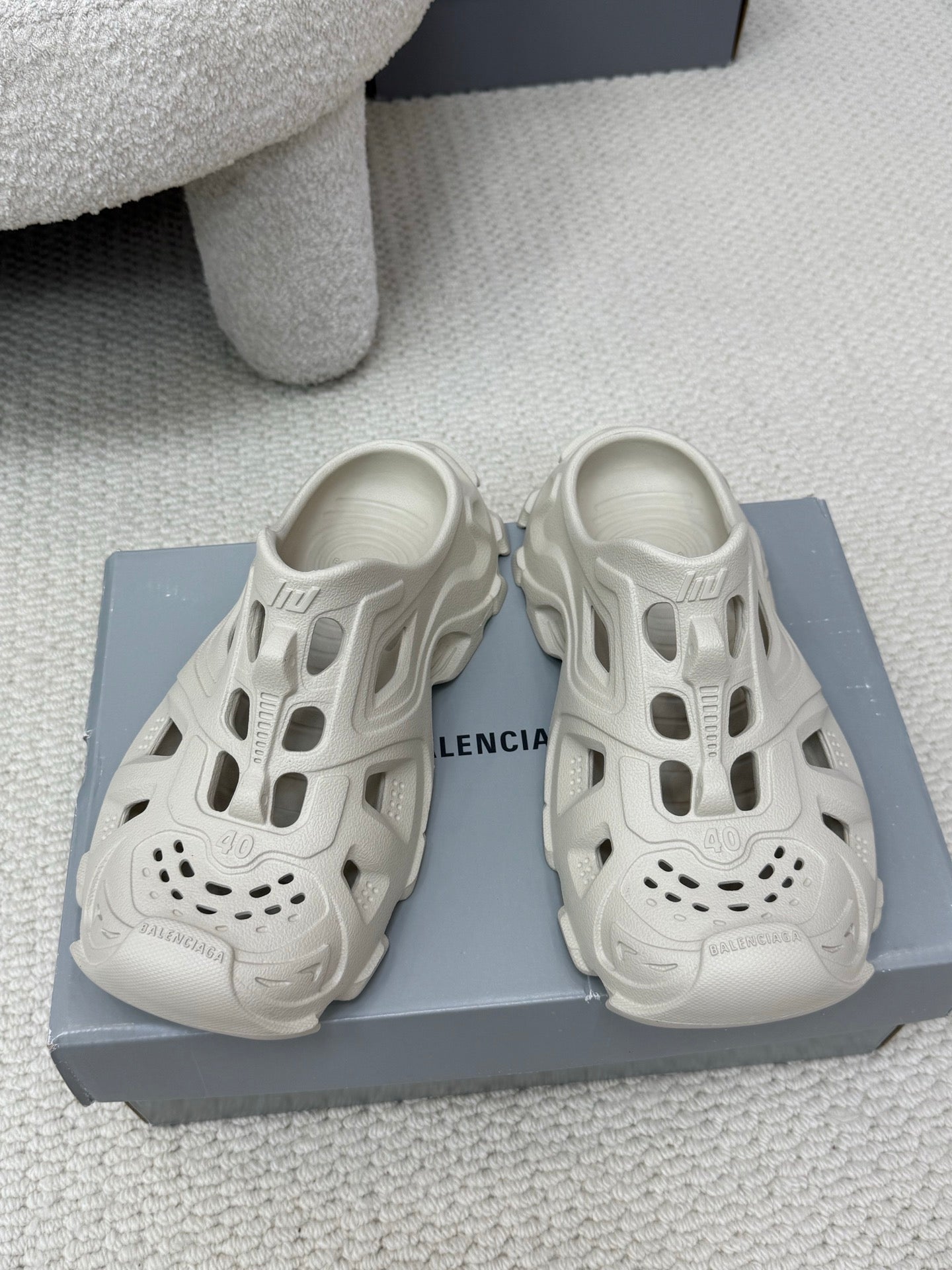Balenciaga white slide sandals with cutout upper, perforated toe, and chunky sole