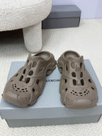Balenciaga beige slide sandals with cutout upper, perforated toe, and chunky sole