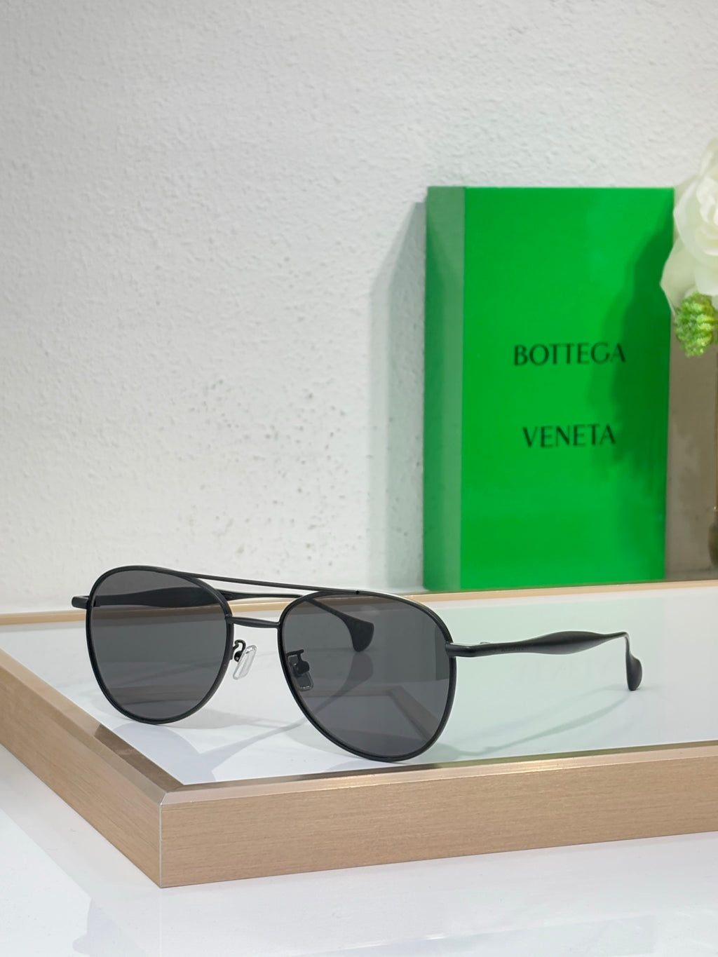Round sunglasses with black frame and dark gray lenses.
