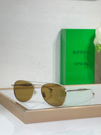 Round sunglasses with clear frame and amber tinted lenses.