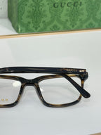 Gucci eyeglasses with black rectangular frame and Gucci logo at temple
