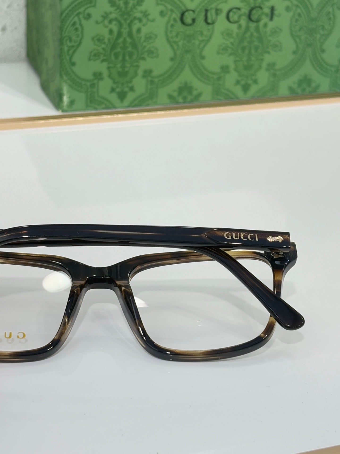 Gucci eyeglasses with black rectangular frame and Gucci logo at temple