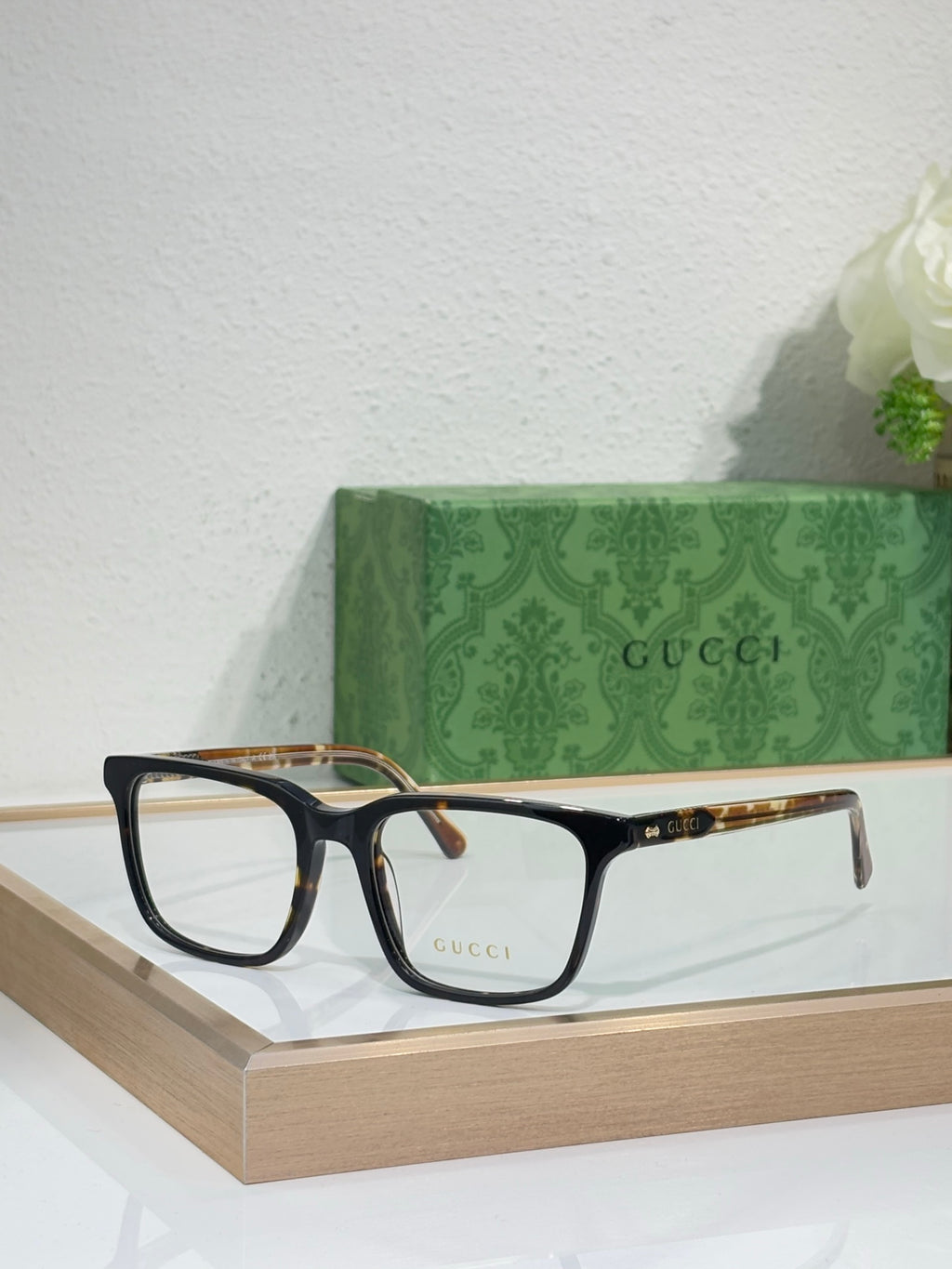 Gucci eyeglasses with black rectangular frame and brown tortoise temple tips