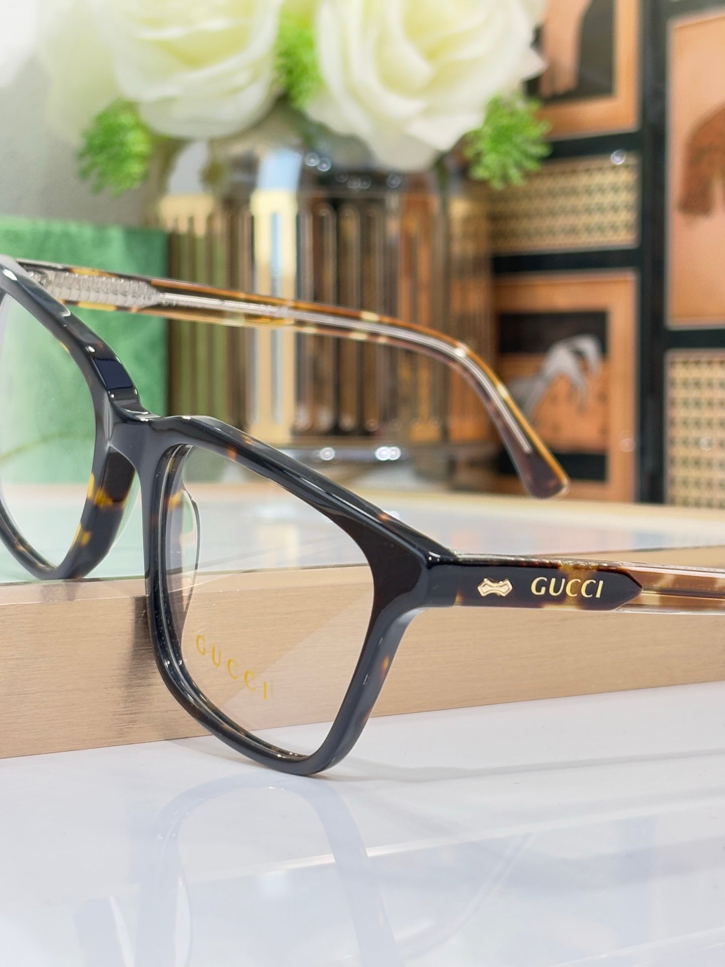 Gucci eyeglasses with black rectangular frame and gold-tone temple detail