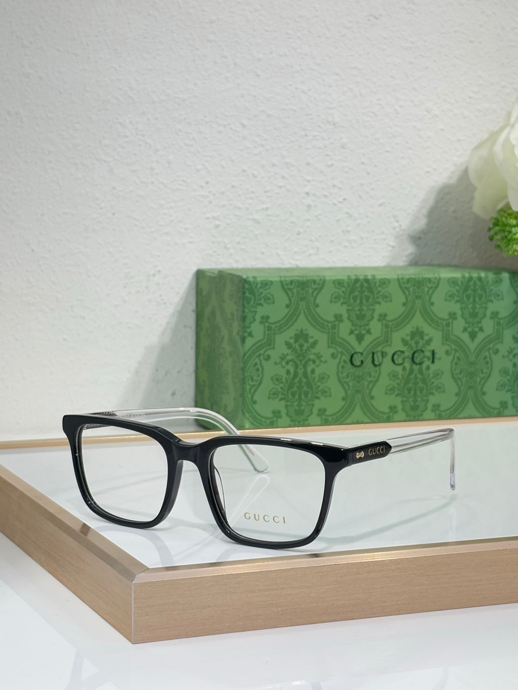Gucci eyeglasses with black rectangular frame and clear lenses, front view