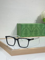 Gucci eyeglasses with black rectangular frame and clear lenses, front view