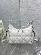 White quilted shoulder bag with structured shape and white crossbody strap
