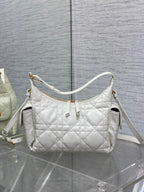 White quilted shoulder bag with gold-tone hardware and adjustable crossbody strap