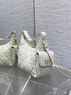 White quilted shoulder bag with gold CD-style emblem and crossbody strap