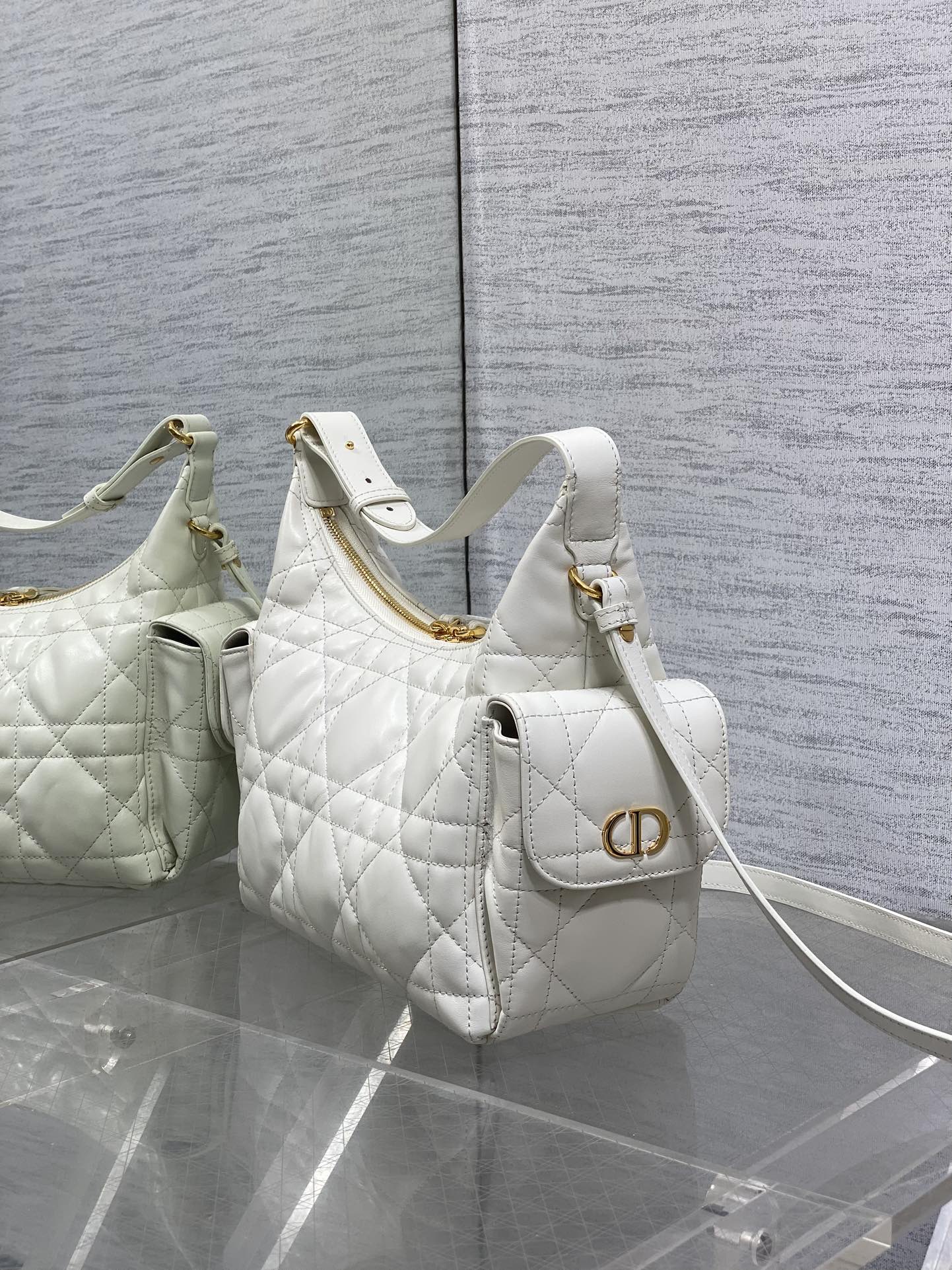 White quilted shoulder bag with gold CD-style emblem and crossbody strap