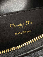 Leather bag label reading Christian Dior, MADE IN ITALY, near gold zipper
