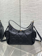 Black quilted hobo bag with top handle, shoulder strap, and gold-tone trim