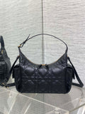 Black quilted hobo bag with top handle, shoulder strap, and gold-tone hardware