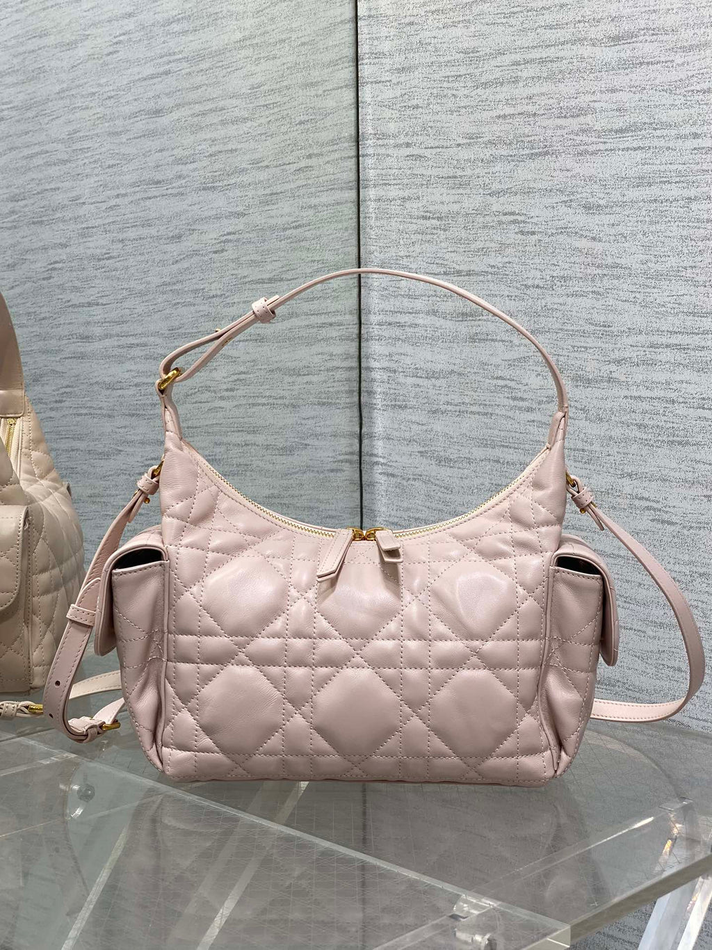 Light pink quilted shoulder bag with gold-tone hardware and top zipper