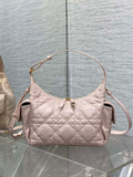 Light pink quilted shoulder bag with gold-tone hardware and top zipper