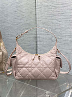 Light pink quilted shoulder bag with gold-tone hardware and top zipper