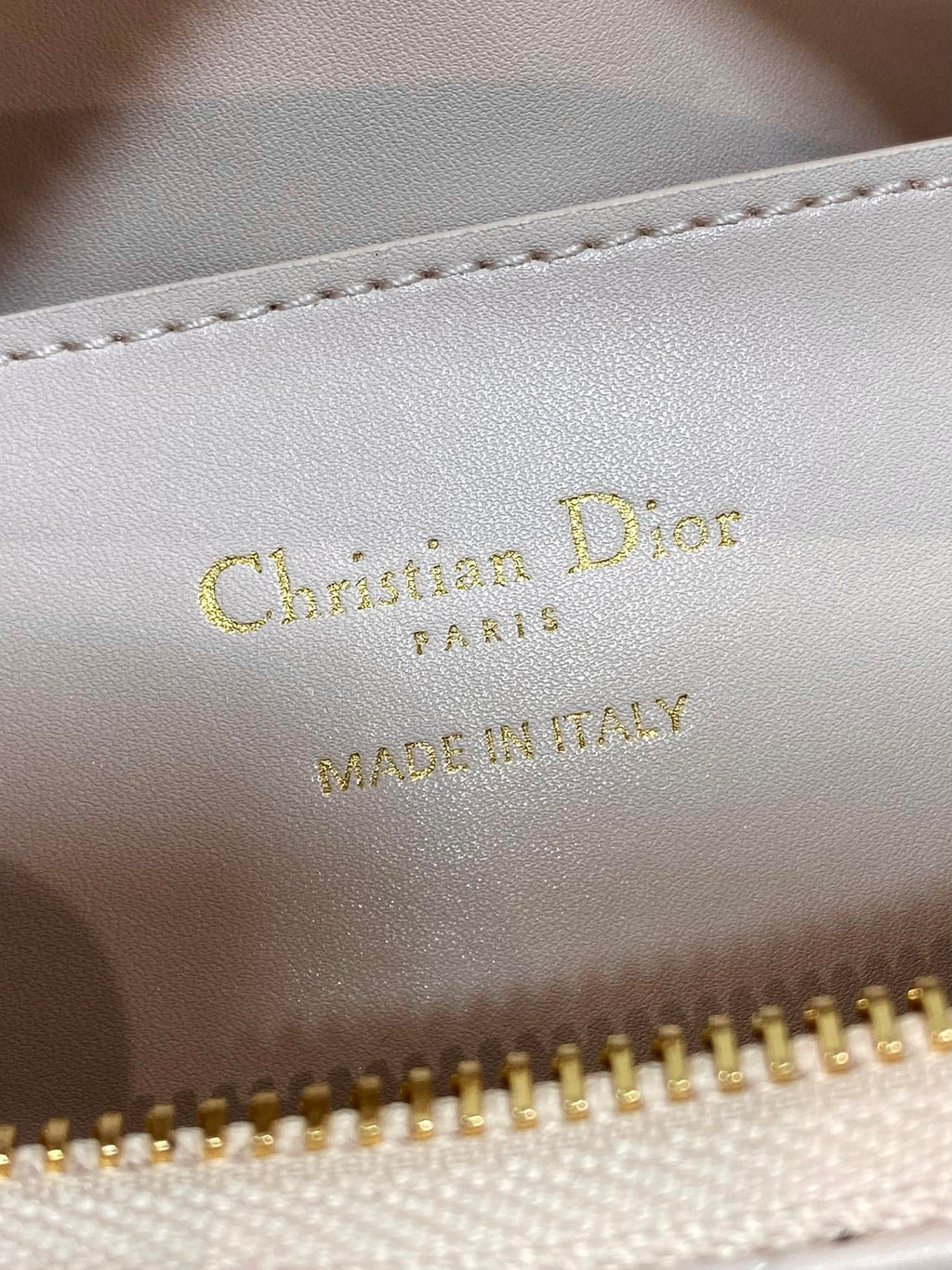 Light pink leather label with gold 'Christian Dior Paris' and 'Made in Italy'