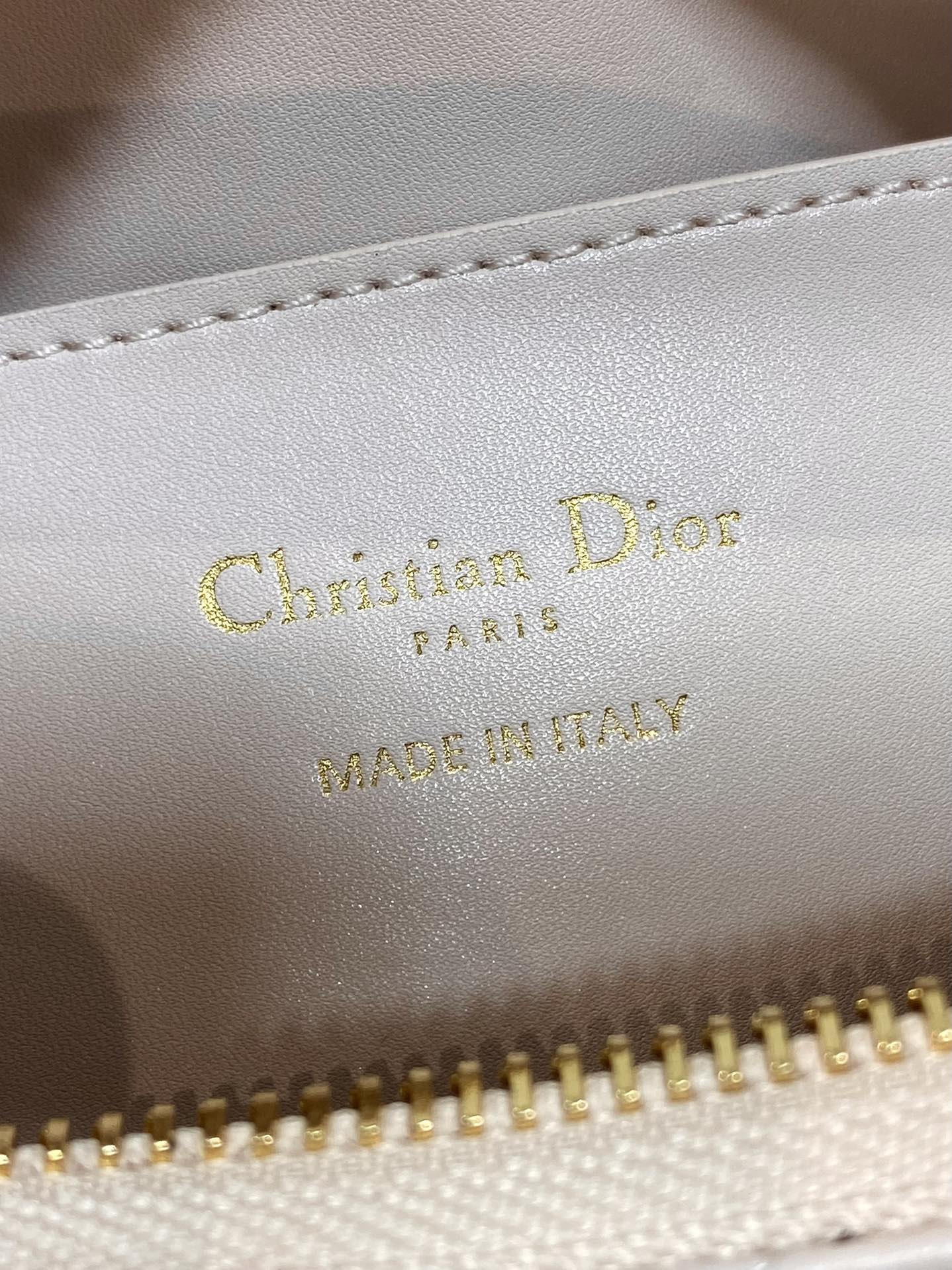 Light pink leather label with gold 'Christian Dior Paris' and 'Made in Italy'